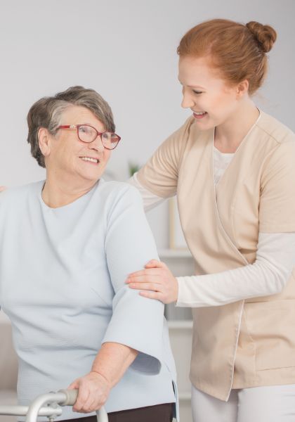 Aged care worker supporting an elderly resident