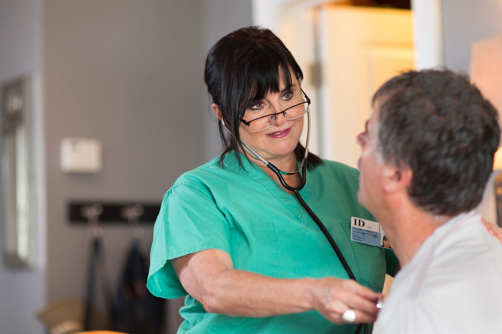 senior-female-nurse-checking-patient-s-heart-2024-06-12-19-34-03-utc
